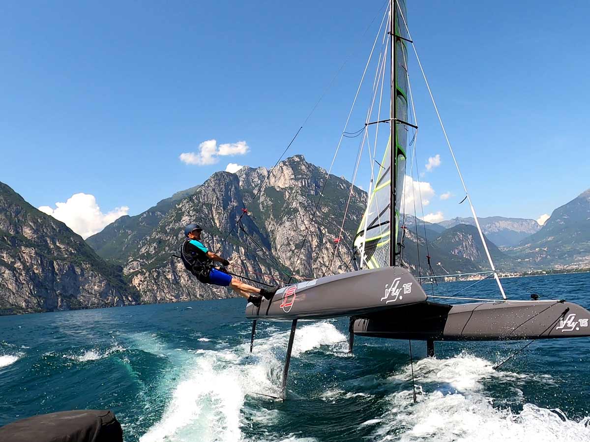 iFLY RAZZOR Pro foiling on Lake Garda – high-speed carbon catamaran utilizing the Ora thermal wind with a performance decksweeper mainsail.